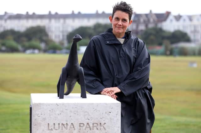 Heather Peak next the to bronze sculpture paying homage to Luna Park. Picture: Sam Stephenson