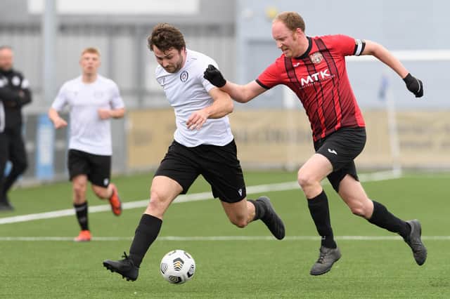 Horndean's Jon Ashford, right, with Lodge's Callum Hill. Picture: Keith Woodland
