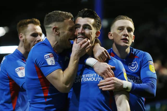 Pompey celebrate John Marquis' 14th goal of the season in the defeat of MK Dons. Picture: Joe Pepler