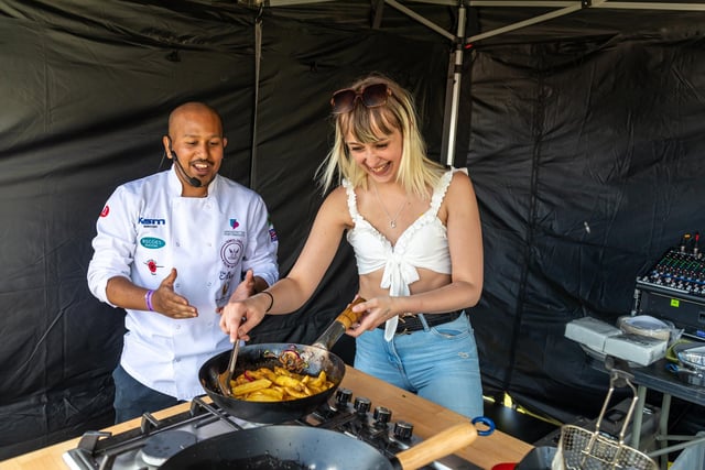 Faz Ahmed from the Akash on Albert Road cooks spicy fries with volunteer chef Lauren Cousens from Romsey. Picture: Mike Cooter (210522)