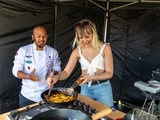 Faz Ahmed from the Akash on Albert Road cooks spicy fries with volunteer chef Lauren Cousens from Romsey. Picture: Mike Cooter (210522)