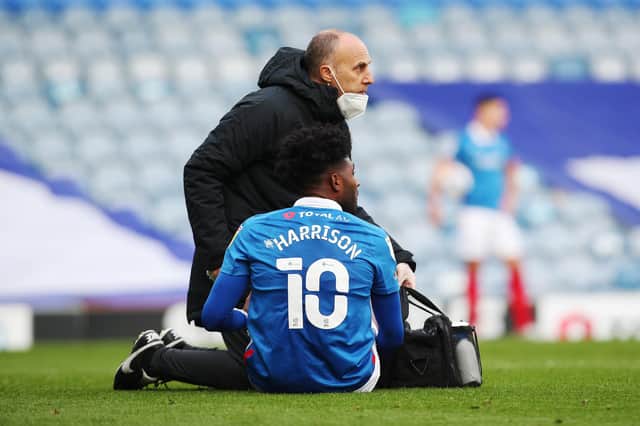 Pompey physio Bobby Bacic assists Ellis Harrison in the second half of today's game.  Picture: Joe Pepler