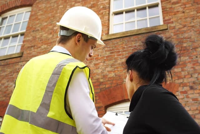 Surveyor with home owner