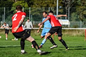Brett Pitman scores one of his four goals for AFC Portchester in their FA Vase win at East Cowes. Picture by Daniel Haswell.