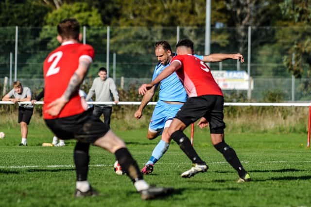 Brett Pitman scores one of his four goals for AFC Portchester in their FA Vase win at East Cowes. Picture by Daniel Haswell.