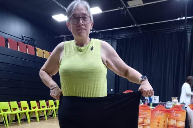 Vicky fitting in one leg of her old trousers