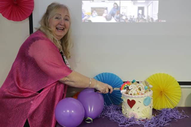 Growing Places is celebrating 20 years of Community Childcare Centres. Pictured: Jackie Warren, director of Growing Places, cutting the birthday cake