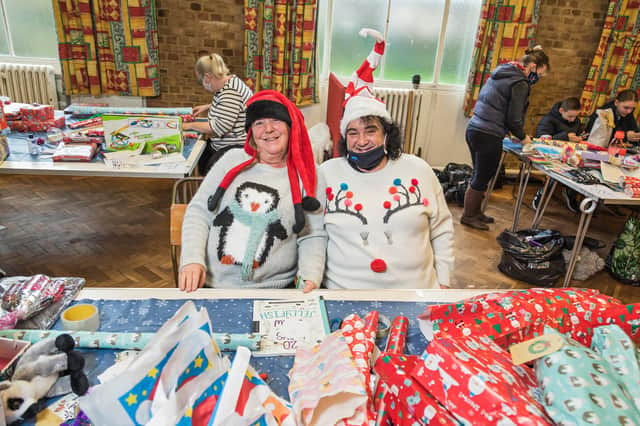 Deborah Young and Angela Palmer show off their Christmas jumpers while volunteering for the first time at The Big Wrap 2020 Picture: Mike Cooter