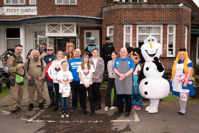 Cosplayers and Disney characters join the Dormer family and the landlord of the Hampshire Rose to raise money for Hannahs Holiday Homes

Picture: Keith Woodland