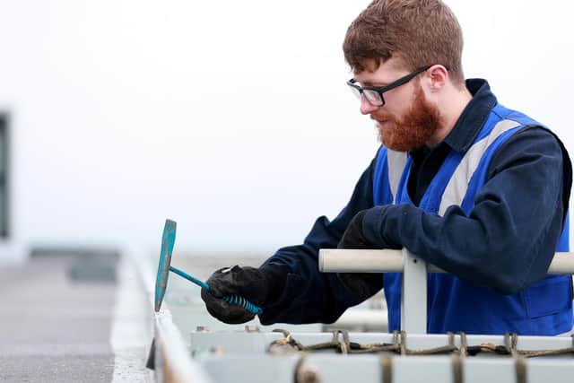 Air Crewmen chipping away paint ready for painting and in preparation for Basic Sea Training on board HMS Queen Elizabeth on the May 8 2020. Picture: LPhot Luke/ Royal Navy
