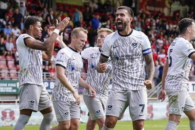 The Pompey players celebrate in front of the Blues' supporters at Brisbane Road. Picture: Jason Brown.