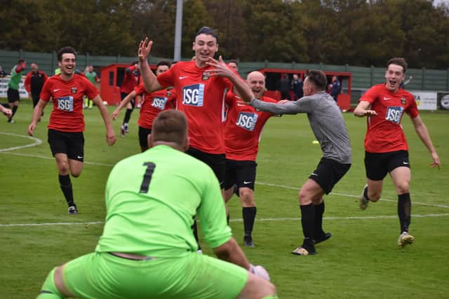 Jon Webb is about to be mobbed by  Fareham players after saving a second Jersey Bulls penalty to give his side a shoot-out victory in the FA Vase. Picture: Paul Proctor