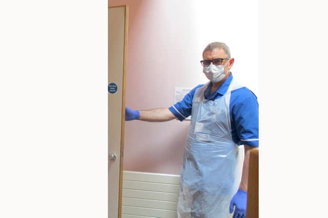 A member of staff at Rowans Hospice wearing PPE