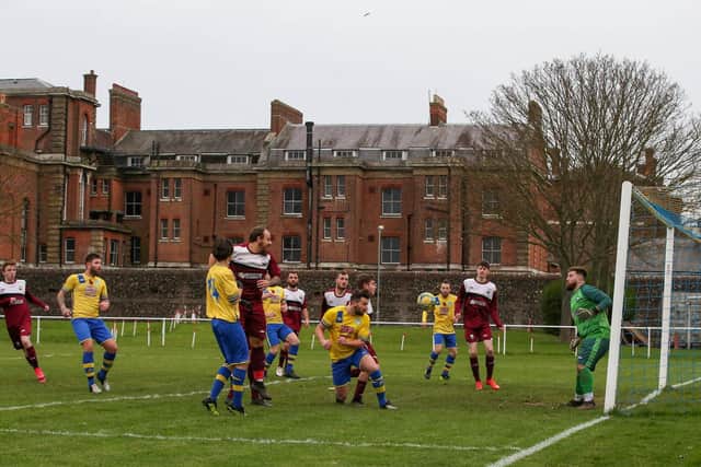 Dale Holmes (centre, going down on one knee) heads one of his four goals against AFC Netley. Picture: Andy Nunn