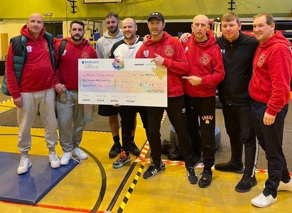 Pictured are the Paulsgrove and Ted Baker AFC coiaching team with a cheque for money raised for Friends Fighting Cancer.