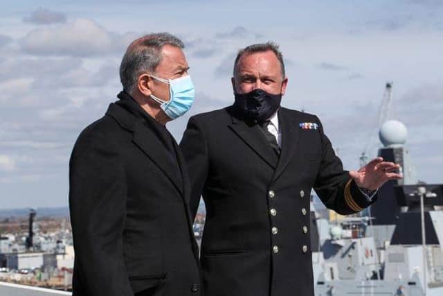Image of Commander Air, Philip Beacham (right), leads a tour of the flight deck with His Excellency Hulusi Akar (left).