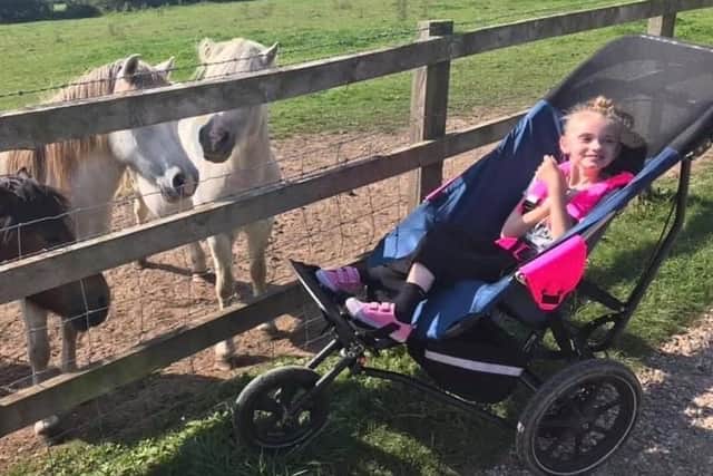 Lucy Glenn on a test-ride for the kind of wheelchair her parents are fundraising to buy her - it costs £3,600