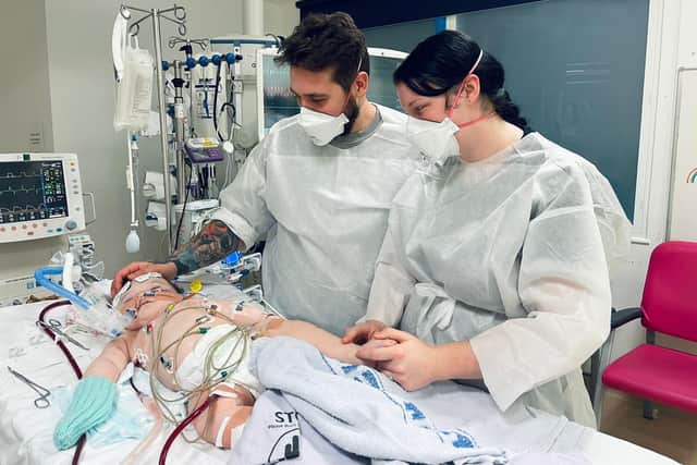 Mariah and Liam Doyle by their son's Hudson's side while he recovered in hospital. Picture: Mariah Allen.