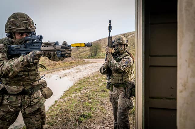 Two Soldiers from 4 PWRR prepare to clear a container during an urban attack.
Photo: Sgt Nick Johns RLC / MoD Crown