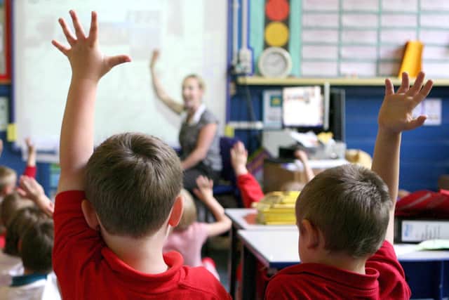 File photo dated 06/07/11 of children at school raising their hands to answer a question as schools. Picture: PA/Dave Thompson