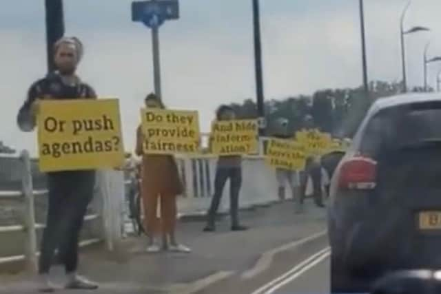 Protesters staged a bizarre anti-vaccine rally on a bridge into Hayling Island on Sunday.