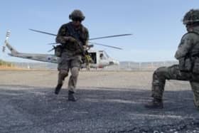 Gunner Tom Cotterill, a journalist with The News, pictured running from a helicopter on exercise with the army in Cyprus