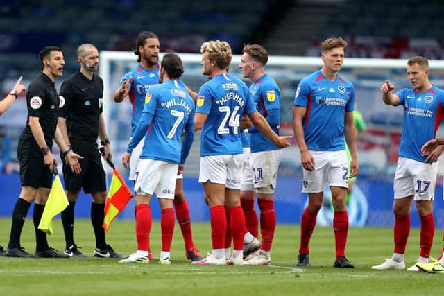 Pompey players surround the referee last night. Andrew Matthews/PA Wire.