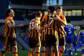 WIMBLEDON, ENGLAND - FEBRUARY 27: Mallik Wilks of Hull City celebrates with Callum Elder after scoring their team's third goal from the penalty spot during the Sky Bet League One match between AFC Wimbledon and Hull City at Plough Lane on February 27, 2021 in Wimbledon, England. Sporting stadiums around the UK remain under strict restrictions due to the Coronavirus Pandemic as Government social distancing laws prohibit fans inside venues resulting in games being played behind closed doors. (Photo by Alex Davidson/Getty Images)