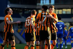 WIMBLEDON, ENGLAND - FEBRUARY 27: Mallik Wilks of Hull City celebrates with Callum Elder after scoring their team's third goal from the penalty spot during the Sky Bet League One match between AFC Wimbledon and Hull City at Plough Lane on February 27, 2021 in Wimbledon, England. Sporting stadiums around the UK remain under strict restrictions due to the Coronavirus Pandemic as Government social distancing laws prohibit fans inside venues resulting in games being played behind closed doors. (Photo by Alex Davidson/Getty Images)