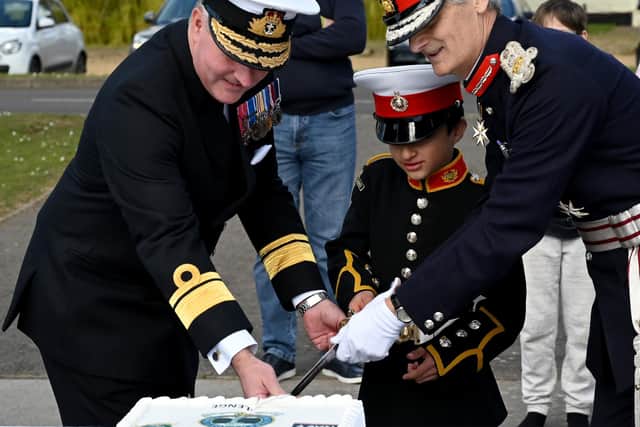 Cadet Samuel Morgan, nine, youngest cadet on parade cutting the VCC120 cutting a cake with Rear Admiral Philip Hally, left, assistant chief of the defence staff, and Nigel Atkinson, right, lord lieutenant of Hampshire.
.
Credit: Kevin Poolman