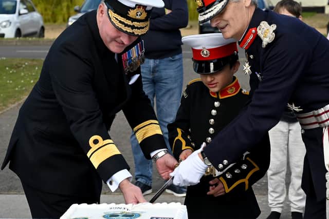 Cadet Samuel Morgan, nine, youngest cadet on parade cutting the VCC120 cutting a cake with Rear Admiral Philip Hally, left, assistant chief of the defence staff, and Nigel Atkinson, right, lord lieutenant  of Hampshire.
.
Credit: Kevin Poolman