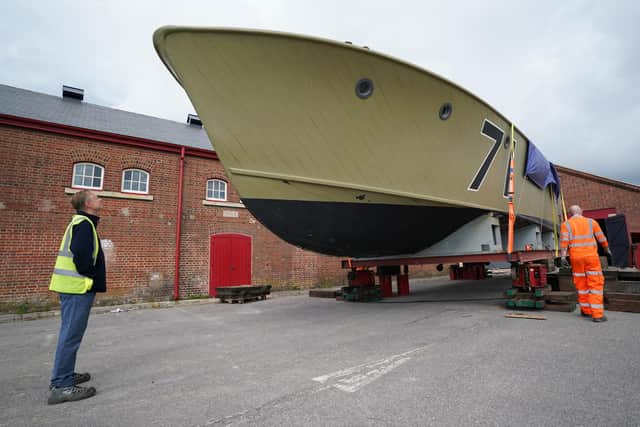 Nick Hewitt, head of research and collections at the National Museum of the Royal Navy, looks up at the historic Second World War Motor Torpedo Boat MTB 71 after it arrived at the National Museum of the Royal Navy's (NMRN) Explosion Museum in Gosport ahead of new Coastal Forces exhibition due to open in Autumn. Picture date: Thursday July 8, 2021.