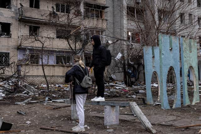People look at the exterior of a damaged residential block hit by an early morning missile strike in Kyiv, Ukraine. Picture: Chris McGrath/Getty Images