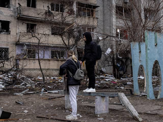 People look at the exterior of a damaged residential block hit by an early morning missile strike in Kyiv, Ukraine. Picture: Chris McGrath/Getty Images