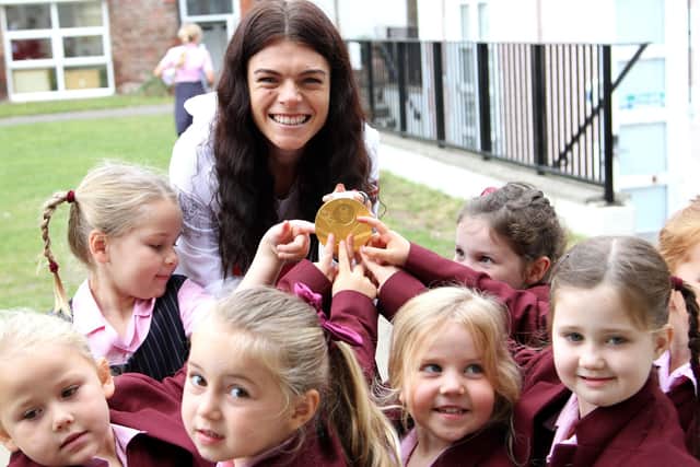 Lauren Steadman with her gold medal and pupils from the prep school at Portsmouth High School