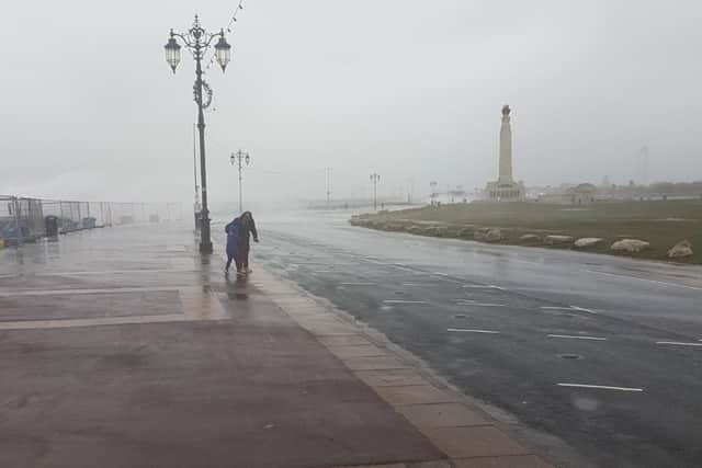 A pair of walkers brace themselves against the rain and wind as Storm Franklin smashed into Portsmouth