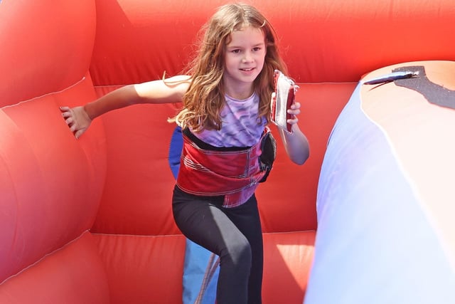 Isla, 9, on one of the many inflatables. Picture by PO Phot Pepe Hogan