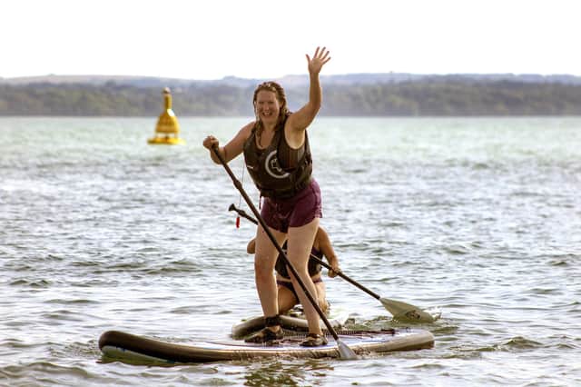 A happy paddle boarder at Stoked Watersports, Gosport.