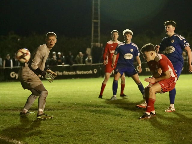 Zack Willett heads Horndean's stoppage time winner against Portland. Picture by Martin Denyer