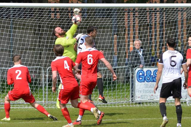 Horndean keeper Cameron Scott punches clear against Bemerton. Picture by Martyn White