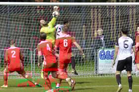 Horndean keeper Cameron Scott punches clear against Bemerton. Picture by Martyn White