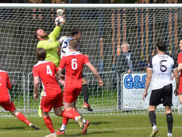 Horndean keeper Cameron Scott punches clear against Bemerton. Picture by Martyn White