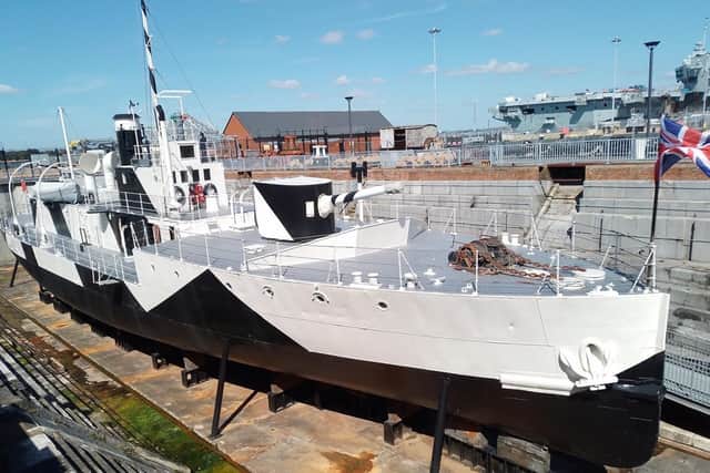 The Monitor HMS M33 in dry dock in Portmouth Naval Base. Note the dazzle camouflage along her side. Picture: Bob Hind.