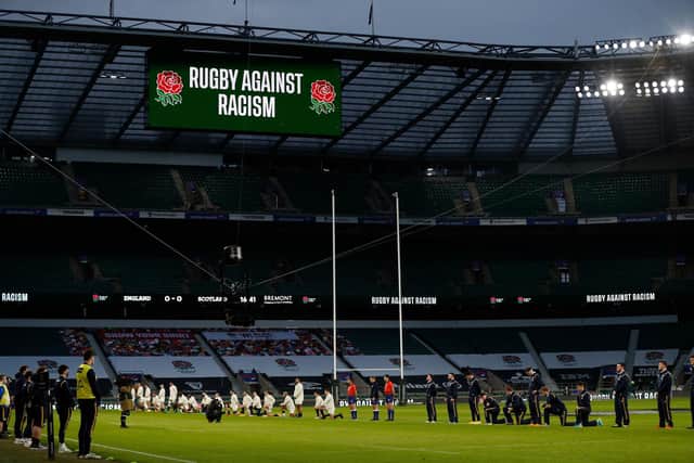 Some players stand and others take the knee in support of the Black Lives Matter movement ahead of the Six Nations match between England and Scotland at Twickenham last month. Photo by Adrian Dennis/AFP via Getty Images.