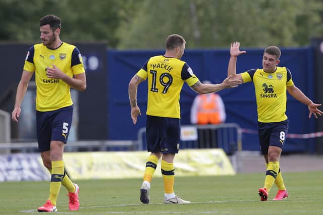 Jamie Mackie and Cameron Brannagan of Oxford United celebrate after Ellis Harrison's own goal. Picture: Robin Jones/Getty Images