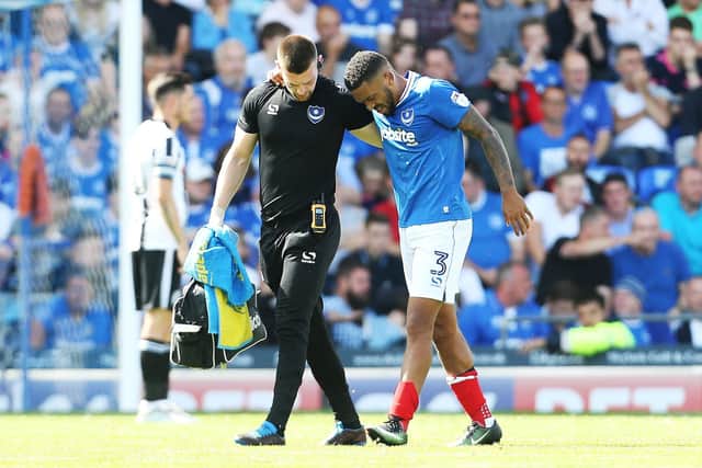 Tareiq Holmes-Dennis is helped off the pitch 39 minutes into his Pompey debut