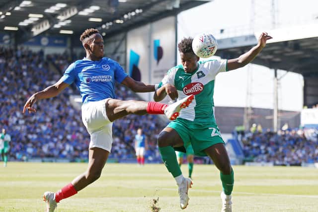 Jamal Lowe battles with Plymouth's Ashley Smith-Brown during a Fratton Park clash in September 2018. Picture: Joe Pepler/Digital South