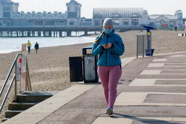 A woman wears a mask in Southsea on March 27, 2020. Picture: Habibur Rahman