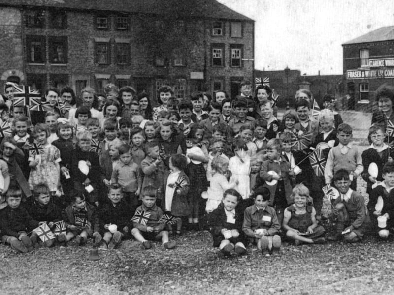 Residents celebrate VE Day in Clarence Square, Gosport, May 1945. Clarence Wharf, Fraser & White Coal Merchants building is on the right.