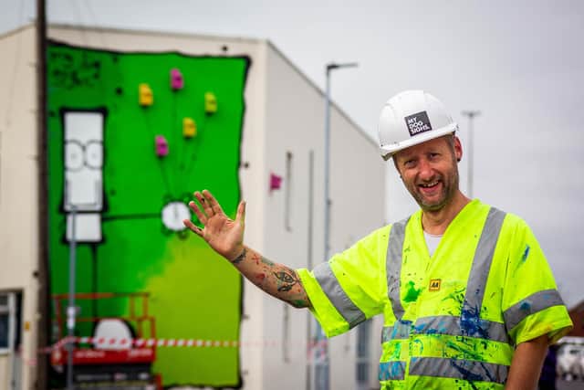 Artist My Dog Sighs, painting a new mural on the Portsmouth Carers building in Francis Avenue, Southsea, on behalf of Wilder Portsmouth on September 28. Picture: Habibur Rahman